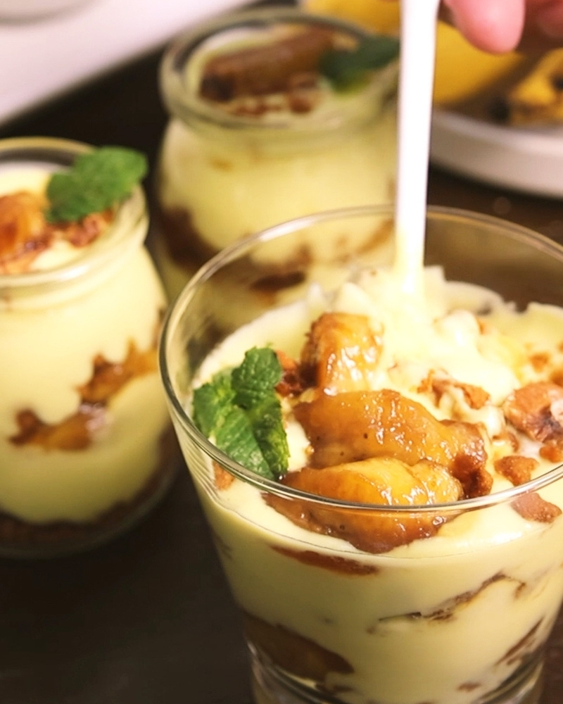Banana Pudding Dessert Individual glass jars of layered banana pudding made with Gutsuka coconut yogurt, topped with caramelized bananas, cookies, and fresh mint.