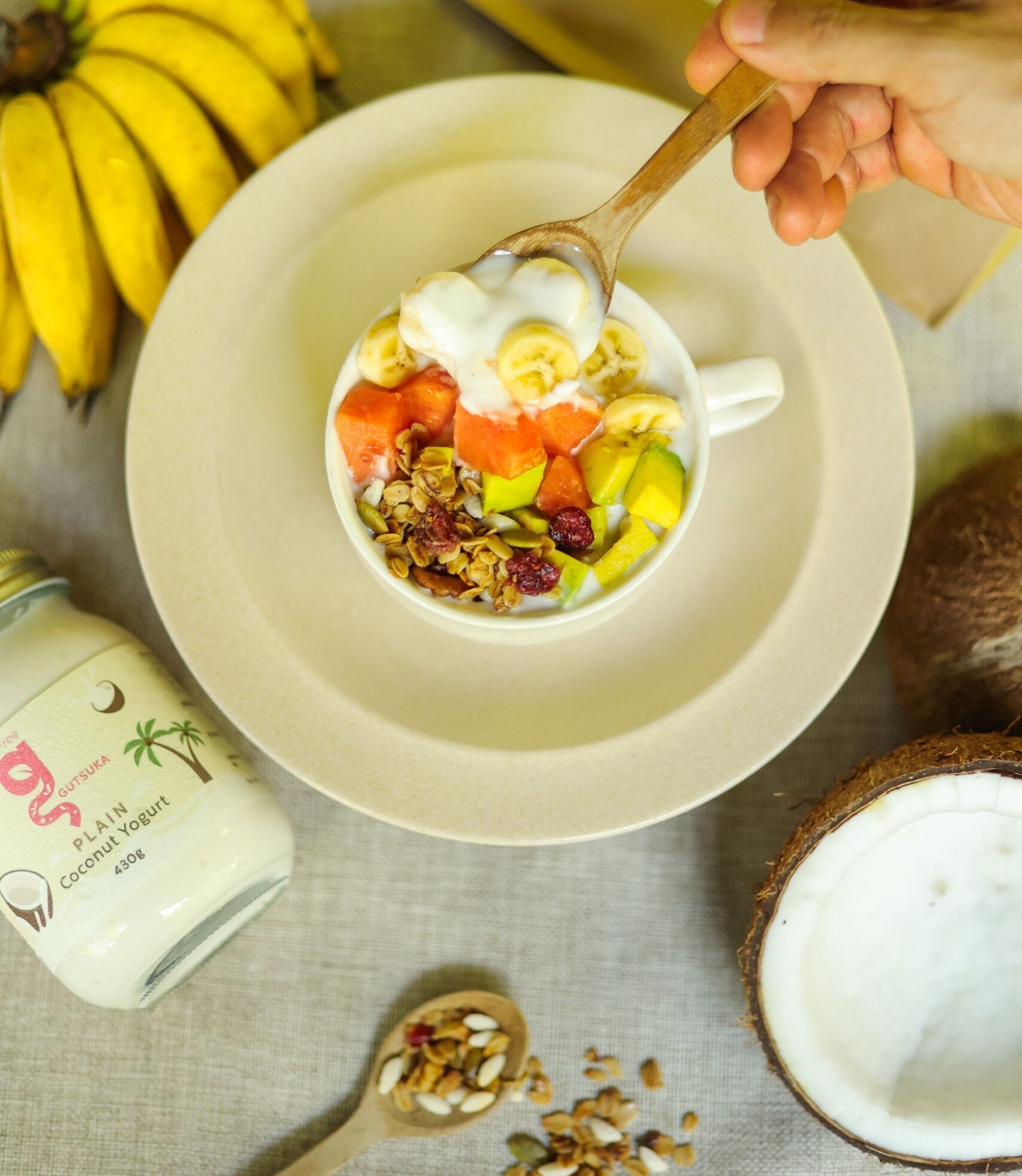 Gutsuka plant-based coconut yogurt bowl topped with fresh fruit and granola