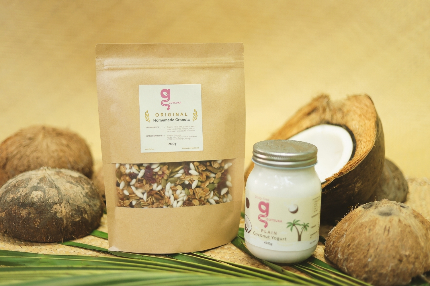 Gutsuka dairy-free coconut yogurt jar with homemade granola and coconut shells.